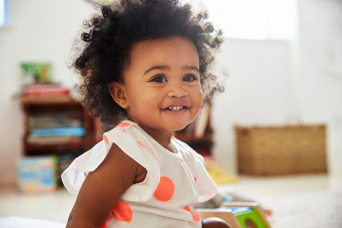 Happy Baby Girl Playing With Toys In Playroom Dupont