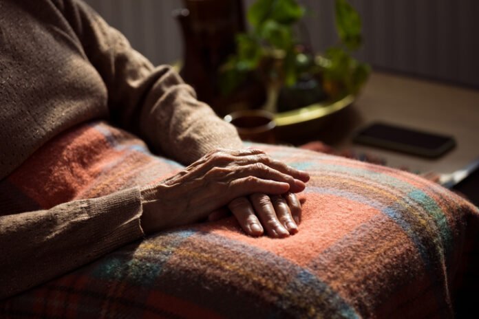Senior woman's hands on blanket Delhi